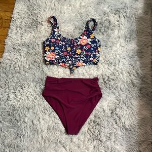 Two piece swimsuit with cropped floral print tank and  solid bottoms 👙